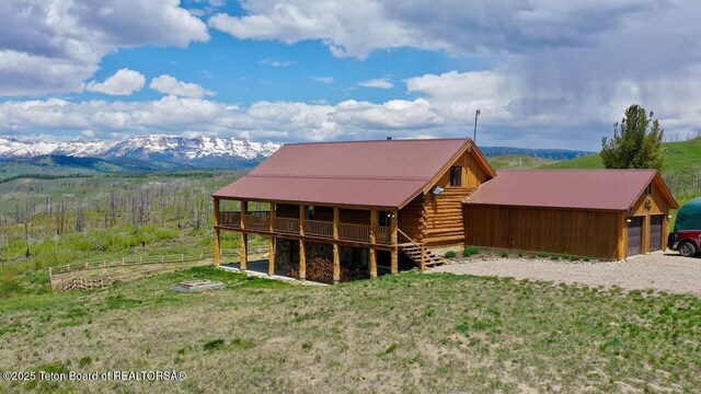 62 Skyline Dr, Bondurant, WY 82922 - rear view of house featuring log siding, a deck with mountain view, and metal roof