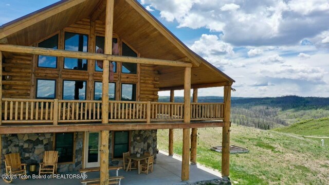 62 Skyline Dr, Bondurant, WY 82922 - back of house with a patio, stone siding, and log siding