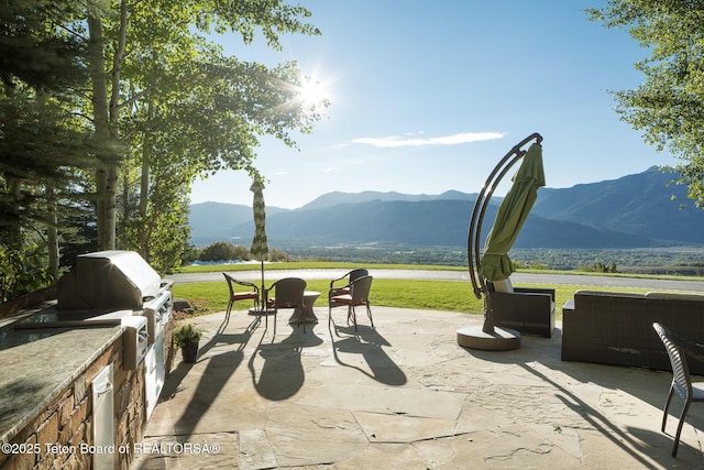 2540 Trader Rd, Jackson, WY 83001 - view of patio / terrace with a mountain view and exterior kitchen