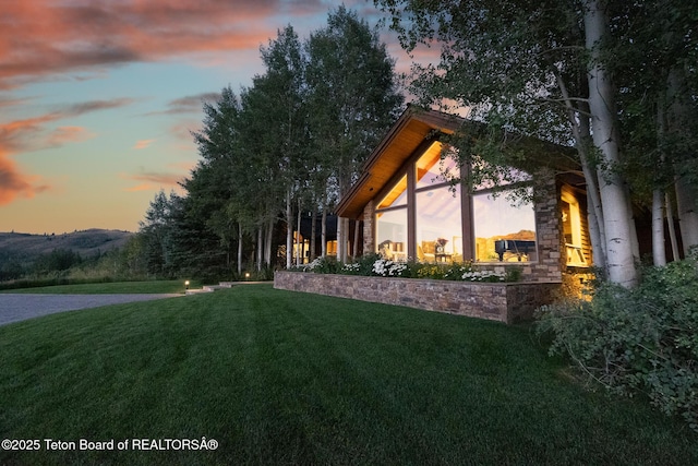 2540 Trader Rd, Jackson, WY 83001 - property exterior at dusk featuring a yard and stone siding