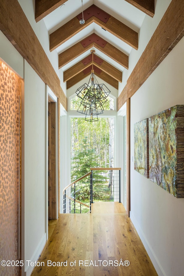 2540 Trader Rd, Jackson, WY 83001 - corridor featuring a chandelier and wood finished floors