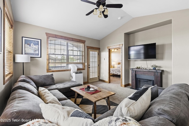715 Moraine Ct Unit 36, Driggs, ID 83422 - living area featuring carpet floors, a ceiling fan, vaulted ceiling, and a glass covered fireplace