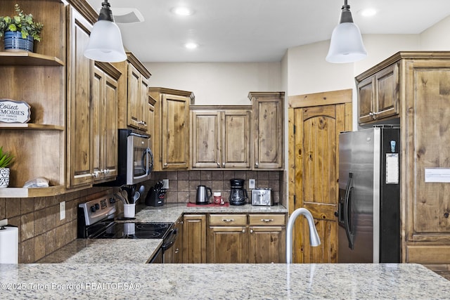 715 Moraine Ct Unit 36, Driggs, ID 83422 - kitchen featuring open shelves, appliances with stainless steel finishes, decorative backsplash, light stone countertops, and recessed lighting