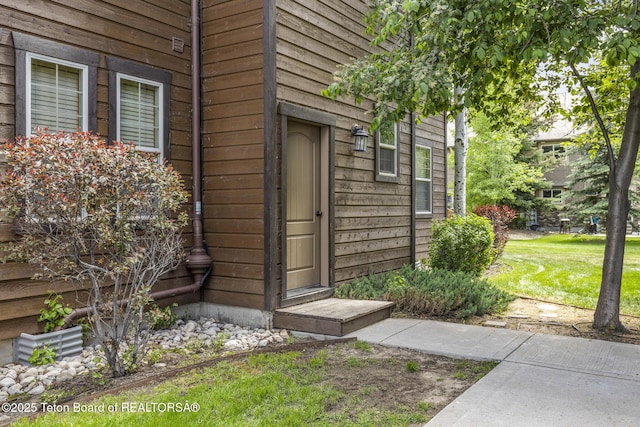 715 Moraine Ct Unit 36, Driggs, ID 83422 - view of exterior entry with a lawn