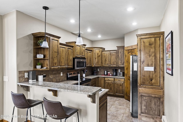 715 Moraine Ct Unit 36, Driggs, ID 83422 - kitchen featuring stainless steel appliances, a peninsula, open shelves, a breakfast bar area, and backsplash