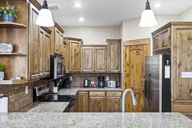 715 Moraine Ct Unit 36, Driggs, ID 83422 - kitchen featuring open shelves, stainless steel appliances, backsplash, light stone countertops, and recessed lighting