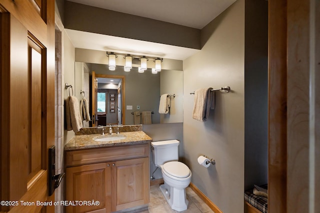3065 N Mountain Maple Ln, Wilson, WY 83014 - half bath with toilet, tile patterned flooring, vanity, and baseboards