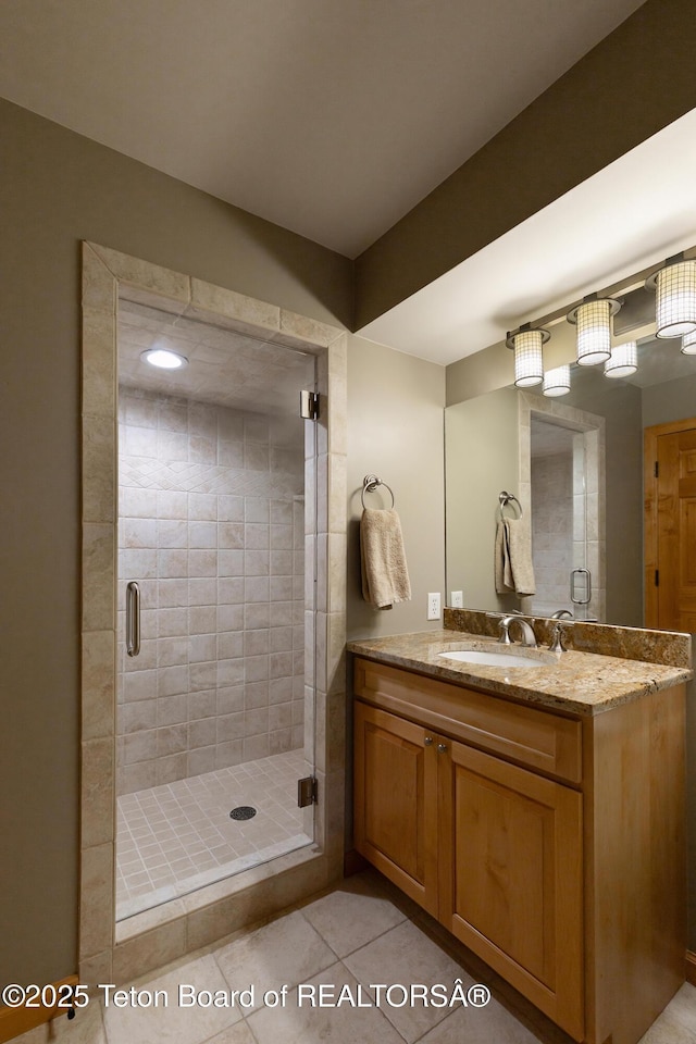 3065 N Mountain Maple Ln, Wilson, WY 83014 - full bathroom with vanity, a stall shower, and tile patterned flooring