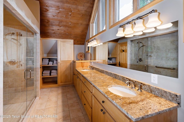 3065 N Mountain Maple Ln, Wilson, WY 83014 - full bathroom featuring double vanity, wood ceiling, a shower stall, tile patterned flooring, and high vaulted ceiling