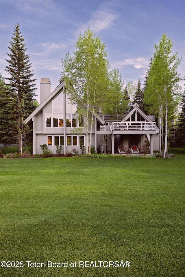 3065 N Mountain Maple Ln, Wilson, WY 83014 - rear view of house featuring a chimney and a lawn