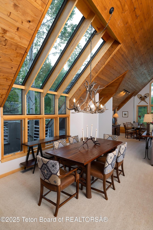 3065 N Mountain Maple Ln, Wilson, WY 83014 - dining space featuring carpet, a chandelier, wood ceiling, vaulted ceiling, and baseboards