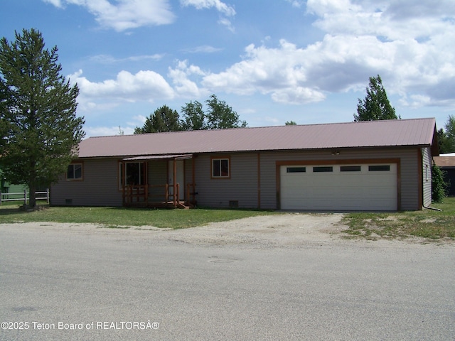 6 Opal St, Pinedale, WY 82941 - ranch-style house featuring dirt driveway, an attached garage, and a metal roof