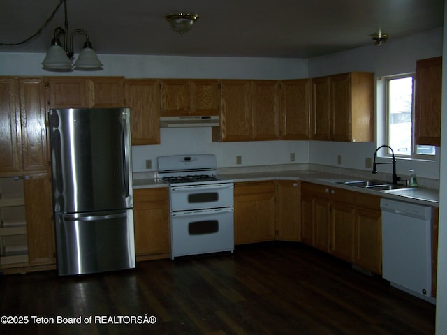 6 Opal St, Pinedale, WY 82941 - kitchen featuring white appliances, under cabinet range hood, light countertops, dark wood-style flooring, and hanging light fixtures