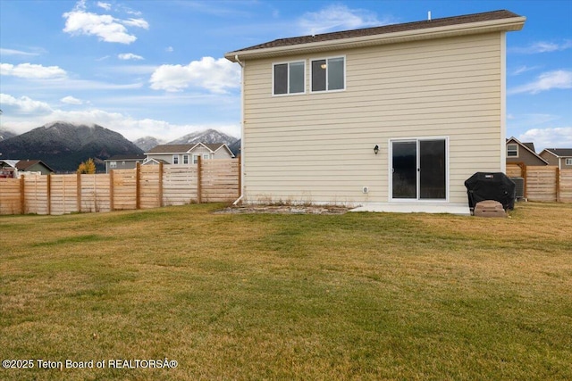 365 Little Greys Lp, Etna, WY 83118 - back of house with a mountain view and a fenced backyard