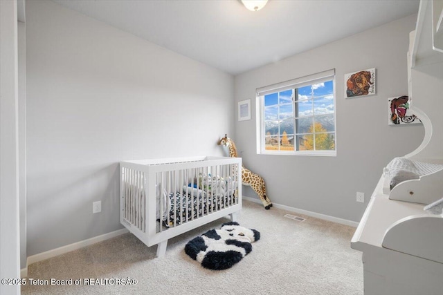 365 Little Greys Lp, Etna, WY 83118 - carpeted bedroom with baseboards and a crib