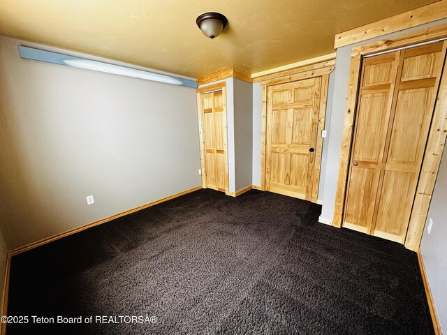 21 Hawk Path, Boulder, WY 82923 - unfurnished bedroom with baseboards and dark carpet