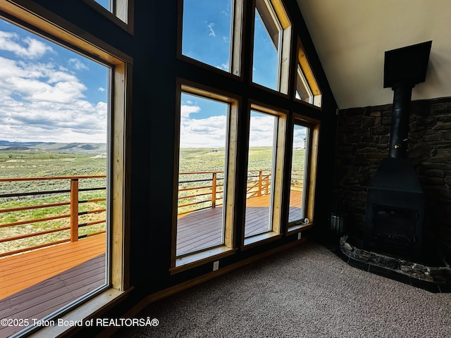 21 Hawk Path, Boulder, WY 82923 - unfurnished sunroom with vaulted ceiling and a wood stove