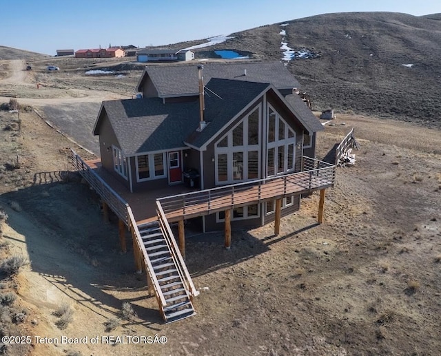 21 Hawk Path, Boulder, WY 82923 - back of property with stairway, a deck with mountain view, and a shingled roof