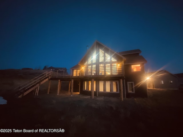 21 Hawk Path, Boulder, WY 82923 - back of house at twilight with a wooden deck and stairs