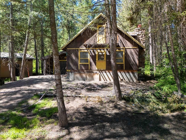 739 Pinecrest, Alpine, WY 83128 - view of front of home featuring a chimney