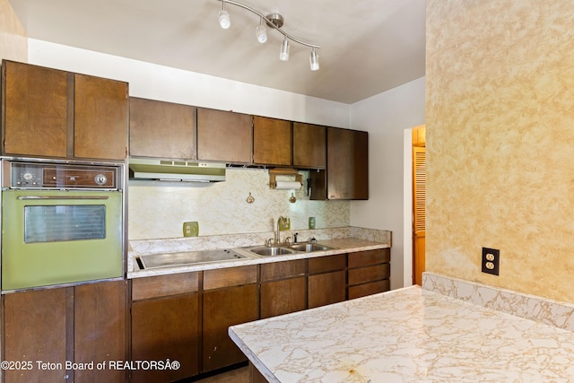 739 Pinecrest, Alpine, WY 83128 - kitchen featuring oven, under cabinet range hood, a sink, electric cooktop, and light countertops