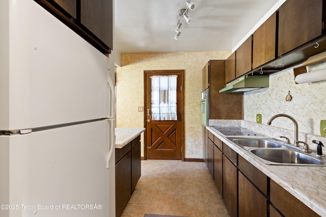 739 Pinecrest, Alpine, WY 83128 - kitchen featuring freestanding refrigerator, a sink, black electric cooktop, light countertops, and under cabinet range hood