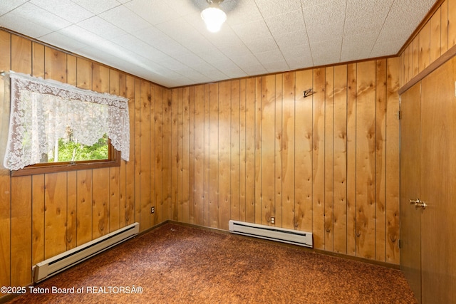 739 Pinecrest, Alpine, WY 83128 - carpeted spare room with a baseboard radiator and wood walls