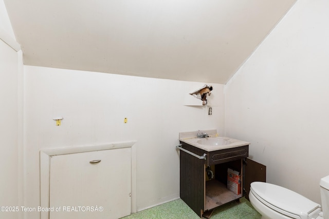 739 Pinecrest, Alpine, WY 83128 - half bathroom with vaulted ceiling, toilet, and vanity