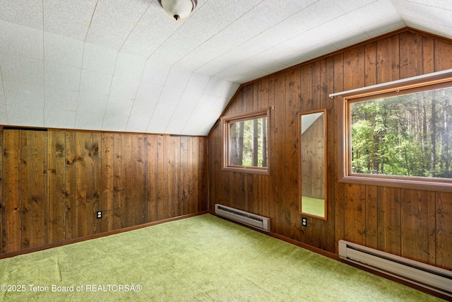 739 Pinecrest, Alpine, WY 83128 - additional living space featuring a baseboard heating unit, vaulted ceiling, wooden walls, and carpet