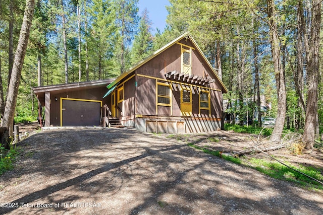 739 Pinecrest, Alpine, WY 83128 - chalet / cabin with dirt driveway and an attached garage
