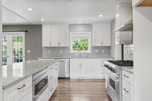 560 Appaloosa Trl, Driggs, ID 83422 - kitchen featuring stainless steel appliances, healthy amount of natural light, under cabinet range hood, a sink, and recessed lighting