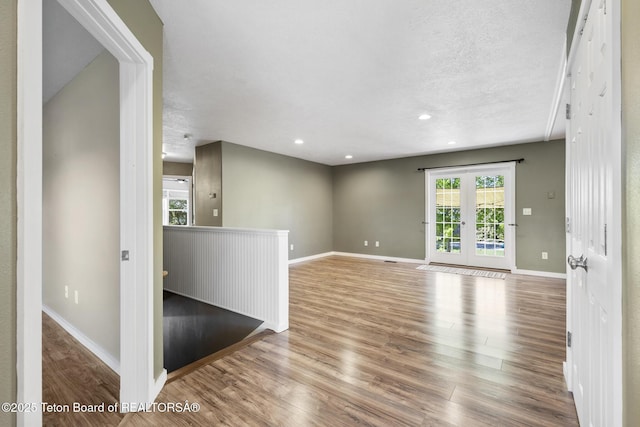 560 Appaloosa Trl, Driggs, ID 83422 - spare room with wood finished floors, baseboards, french doors, recessed lighting, and a textured ceiling
