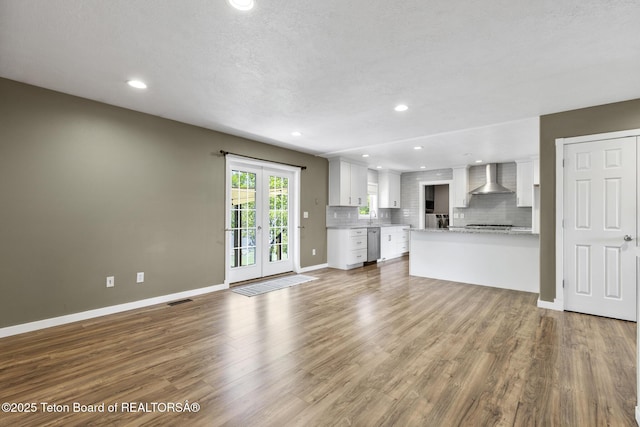560 Appaloosa Trl, Driggs, ID 83422 - unfurnished living room featuring dark wood-style floors, baseboards, recessed lighting, and a sink