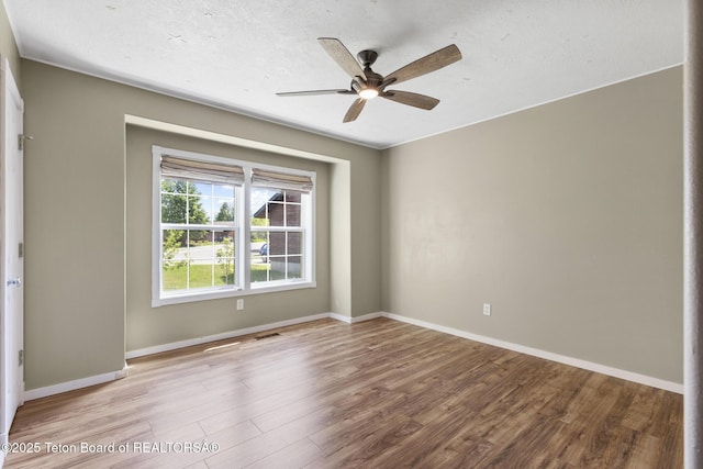560 Appaloosa Trl, Driggs, ID 83422 - spare room featuring wood finished floors, a ceiling fan, and baseboards