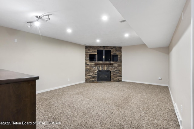 560 Appaloosa Trl, Driggs, ID 83422 - unfurnished living room with carpet floors, a stone fireplace, recessed lighting, and baseboards