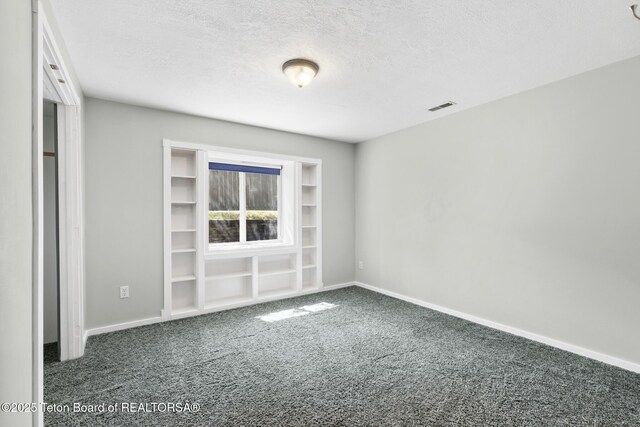 560 Appaloosa Trl, Driggs, ID 83422 - unfurnished room featuring carpet flooring, a textured ceiling, and baseboards