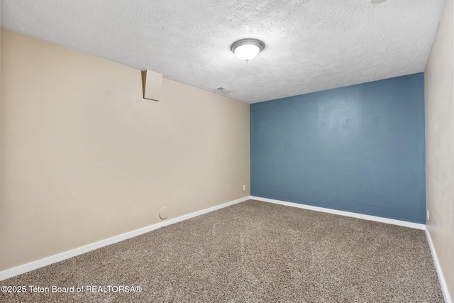 560 Appaloosa Trl, Driggs, ID 83422 - carpeted empty room with a textured ceiling and baseboards