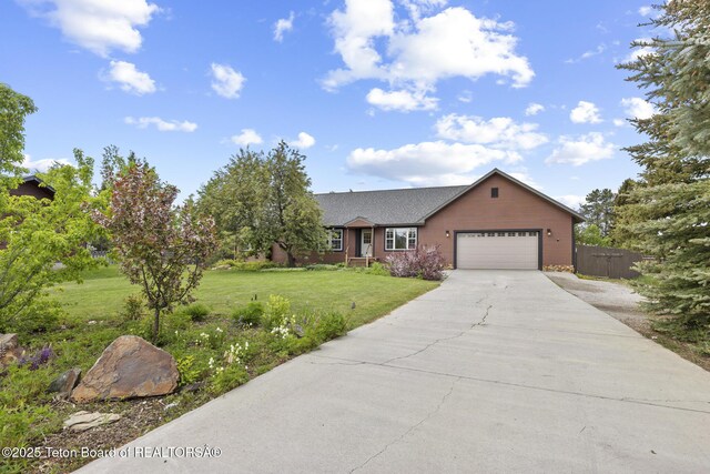 560 Appaloosa Trl, Driggs, ID 83422 - view of front of property featuring a garage, driveway, and roof with shingles
