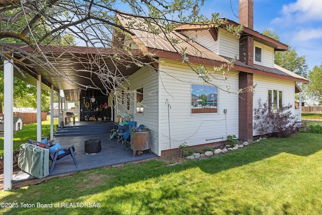 105 Heap Dr, Thayne, WY 83127 - rear view of property with a chimney and a deck