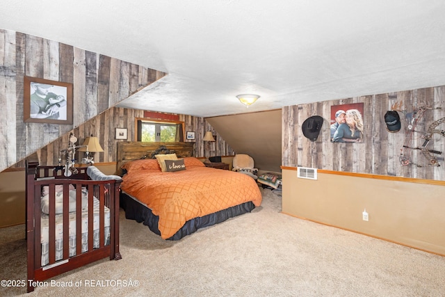 105 Heap Dr, Thayne, WY 83127 - bedroom featuring carpet flooring, wooden walls, and vaulted ceiling