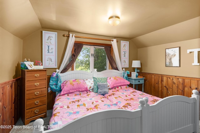 105 Heap Dr, Thayne, WY 83127 - bedroom with vaulted ceiling, wainscoting, and wood walls