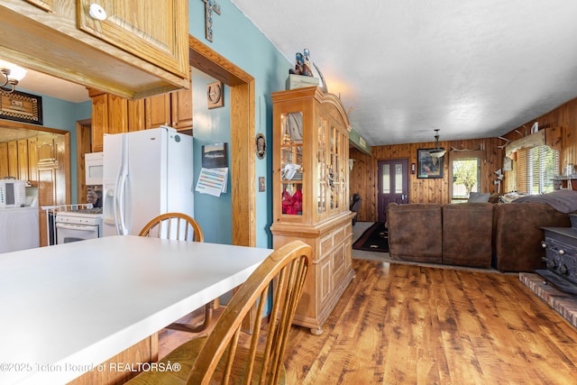 105 Heap Dr, Thayne, WY 83127 - kitchen featuring white appliances, wooden walls, light wood-style floors, and open floor plan