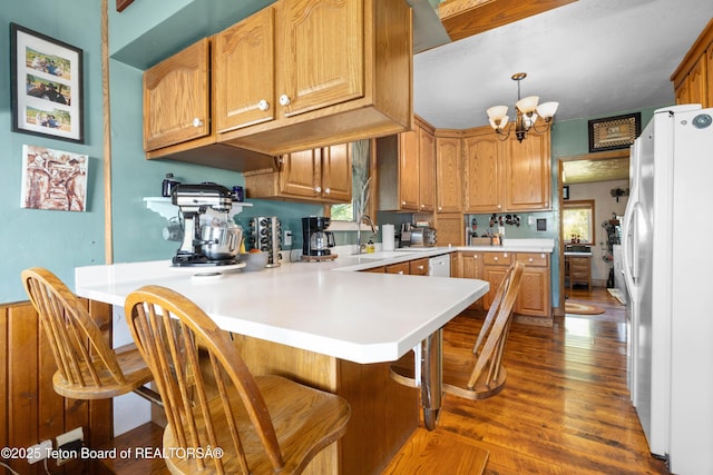 105 Heap Dr, Thayne, WY 83127 - kitchen with white appliances, plenty of natural light, a peninsula, and a chandelier