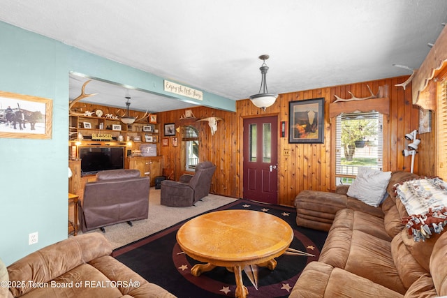 105 Heap Dr, Thayne, WY 83127 - carpeted living area with wooden walls
