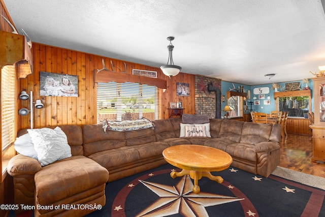 105 Heap Dr, Thayne, WY 83127 - living room featuring wood walls and a textured ceiling