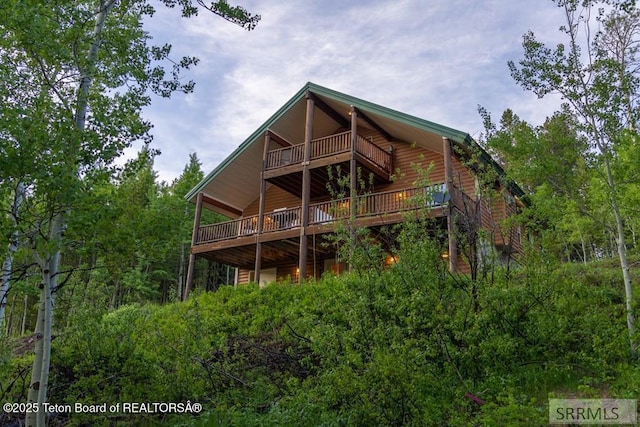 4770 Deer Dr, Island Park, ID 83429 - rear view of house featuring a deck and faux log siding