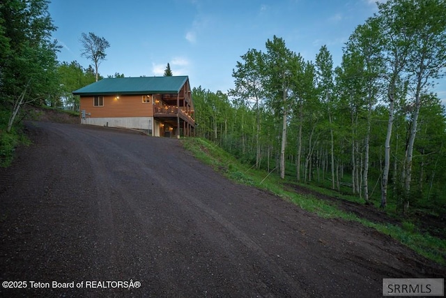 4770 Deer Dr, Island Park, ID 83429 - view of front of home featuring dirt driveway and a view of trees