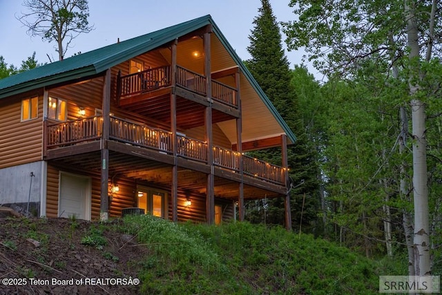 4770 Deer Dr, Island Park, ID 83429 - rear view of house with faux log siding, a deck, and metal roof