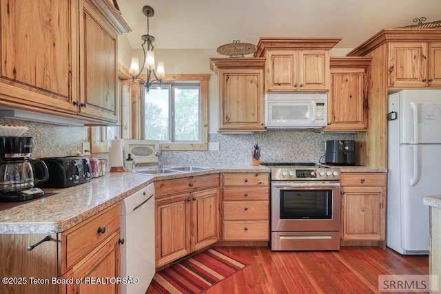 4770 Deer Dr, Island Park, ID 83429 - kitchen with white appliances, a sink, light countertops, dark wood-style flooring, and tasteful backsplash