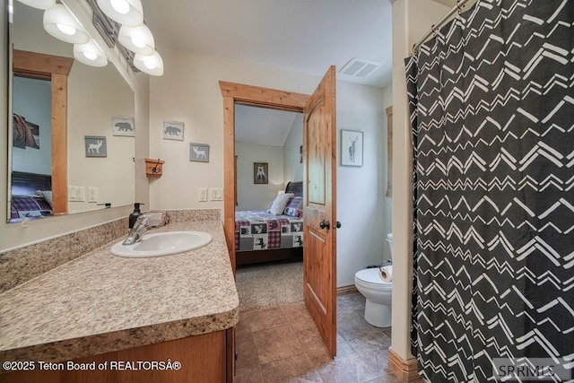 4770 Deer Dr, Island Park, ID 83429 - full bath with ensuite bathroom, vanity, toilet, a shower with shower curtain, and tile patterned floors